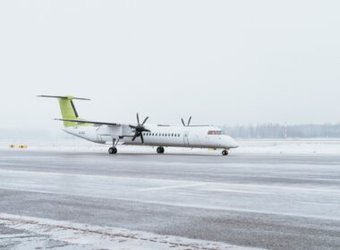 airBaltic Q400 aircraft on a snowy runway in Riga Airport before its redelivery