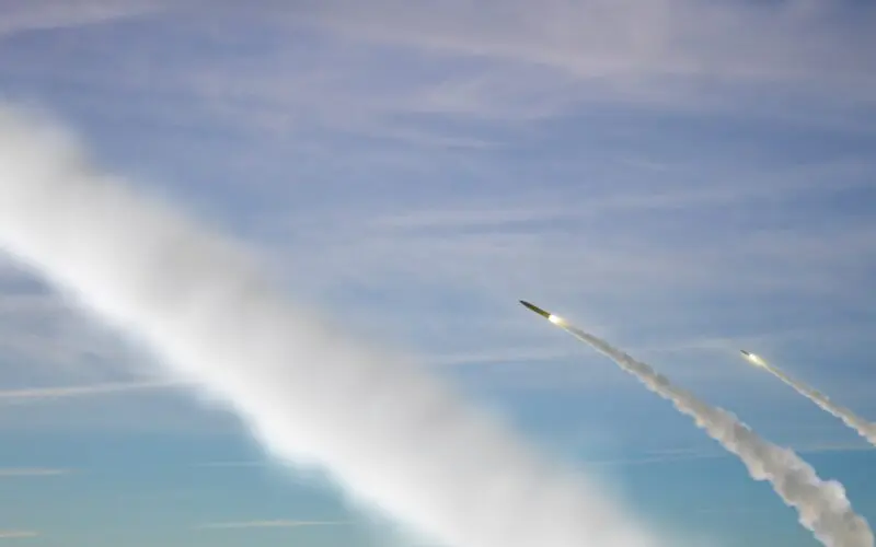 Military rockets are flying against the sky