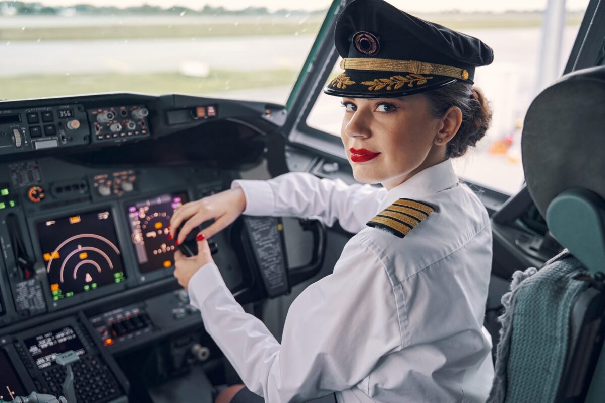 Lady pilot posing for the camera in the cockpit