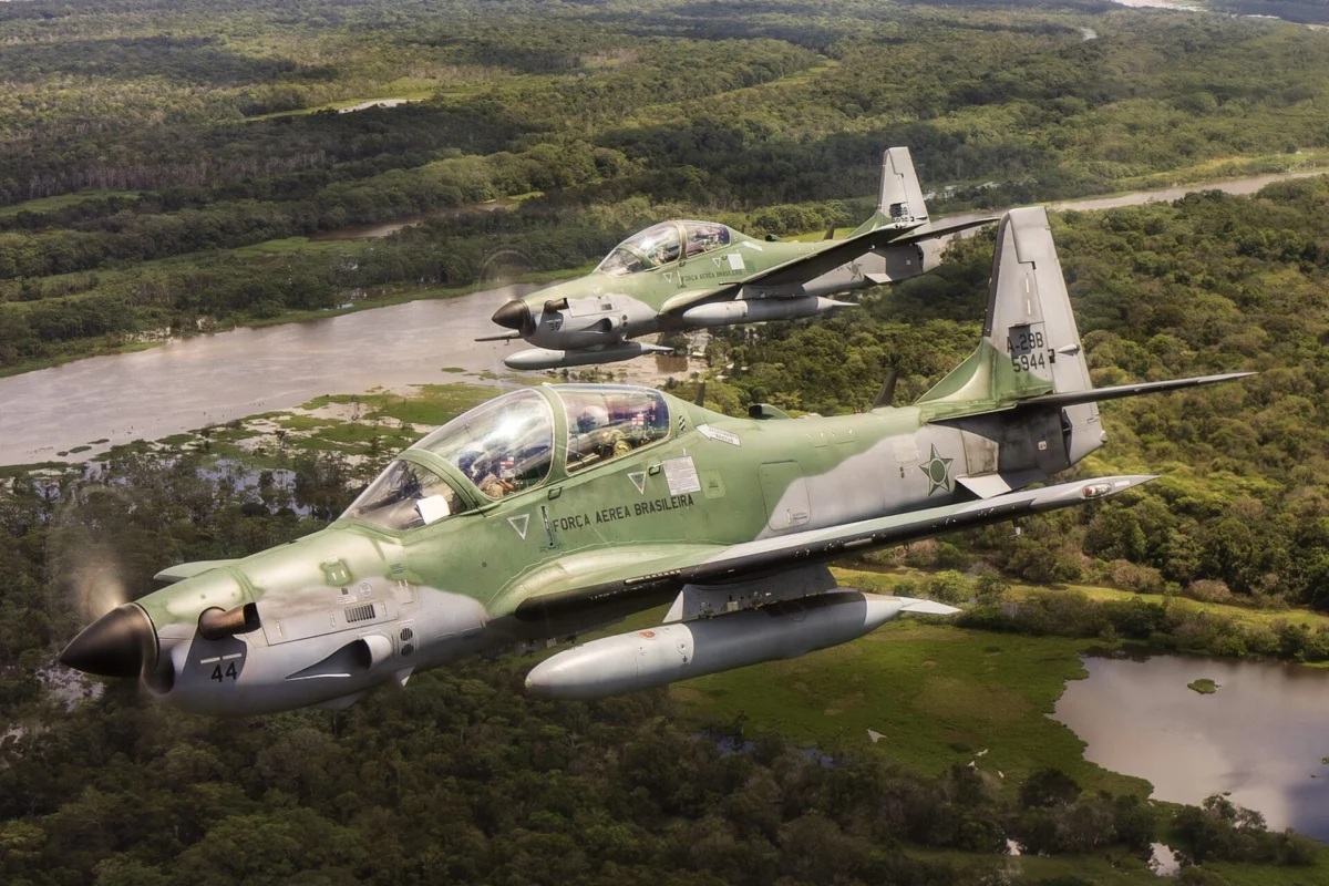 Brazilian Air Force Embraer A 29 Super Tucano aircraft in flight over the Amazon Rainforest Brazilian Air Force Embraer A-29 Super Tucano aircraft in flight over the Amazon Rainforest