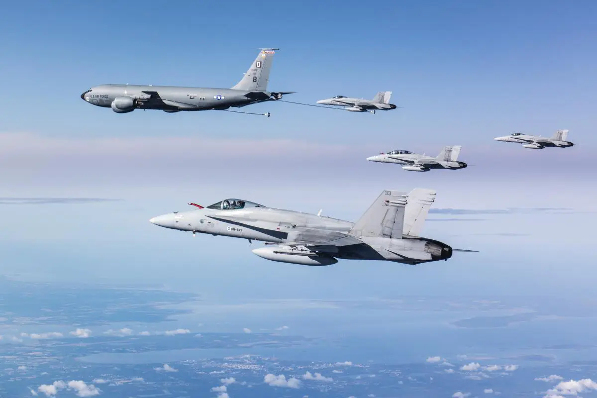 Four Finnish FA 18 Hornet multi role fighters and a USAF KC 135 Stratotanker Four Finnish FA-18 Hornet multi-role fighters and a USAF KC-135 Stratotanker