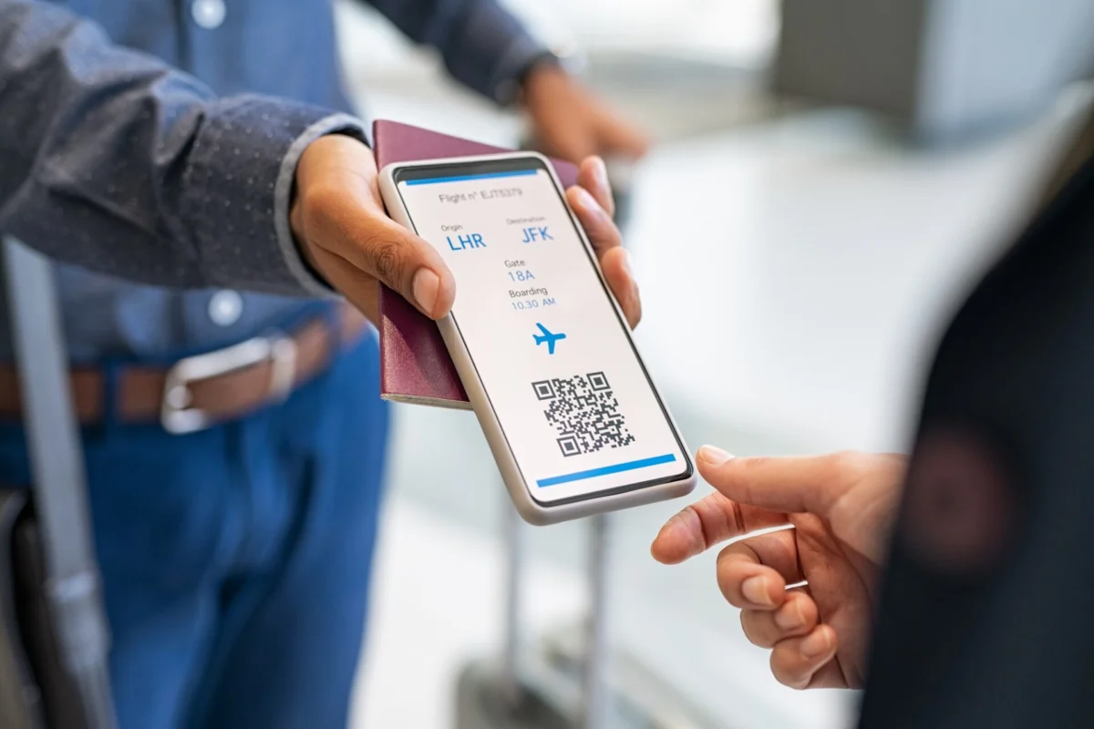 Agent checking electronic flight ticket at boarding gate Agent checking electronic flight ticket at boarding gate