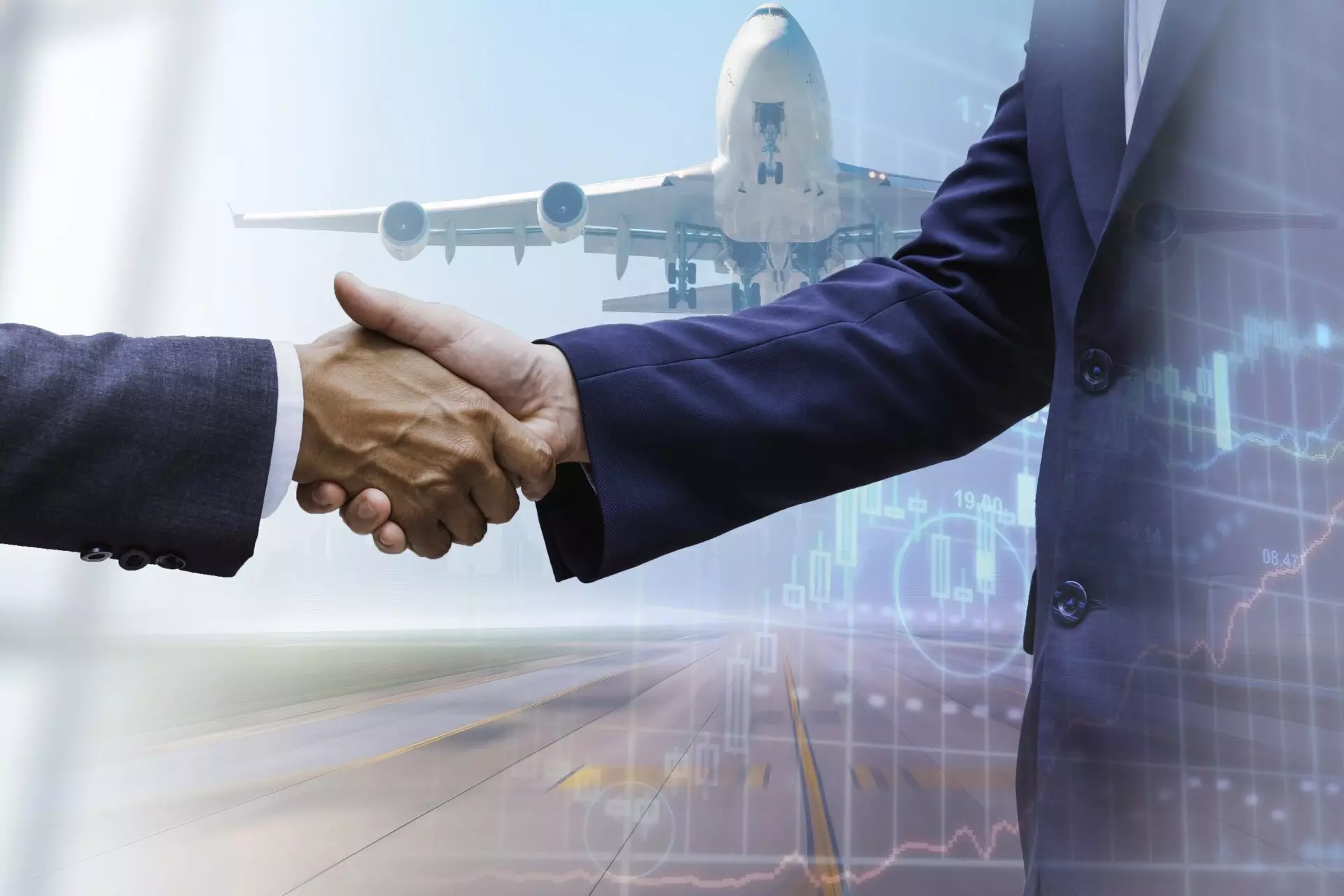 Two men shaking hands by a plane