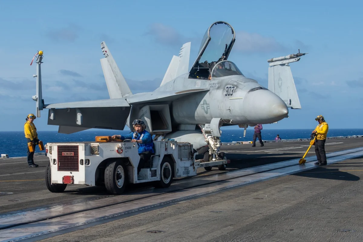US Navy FA-18 Super Hornet being towed onboard USS Truman aircraft carrier (2)