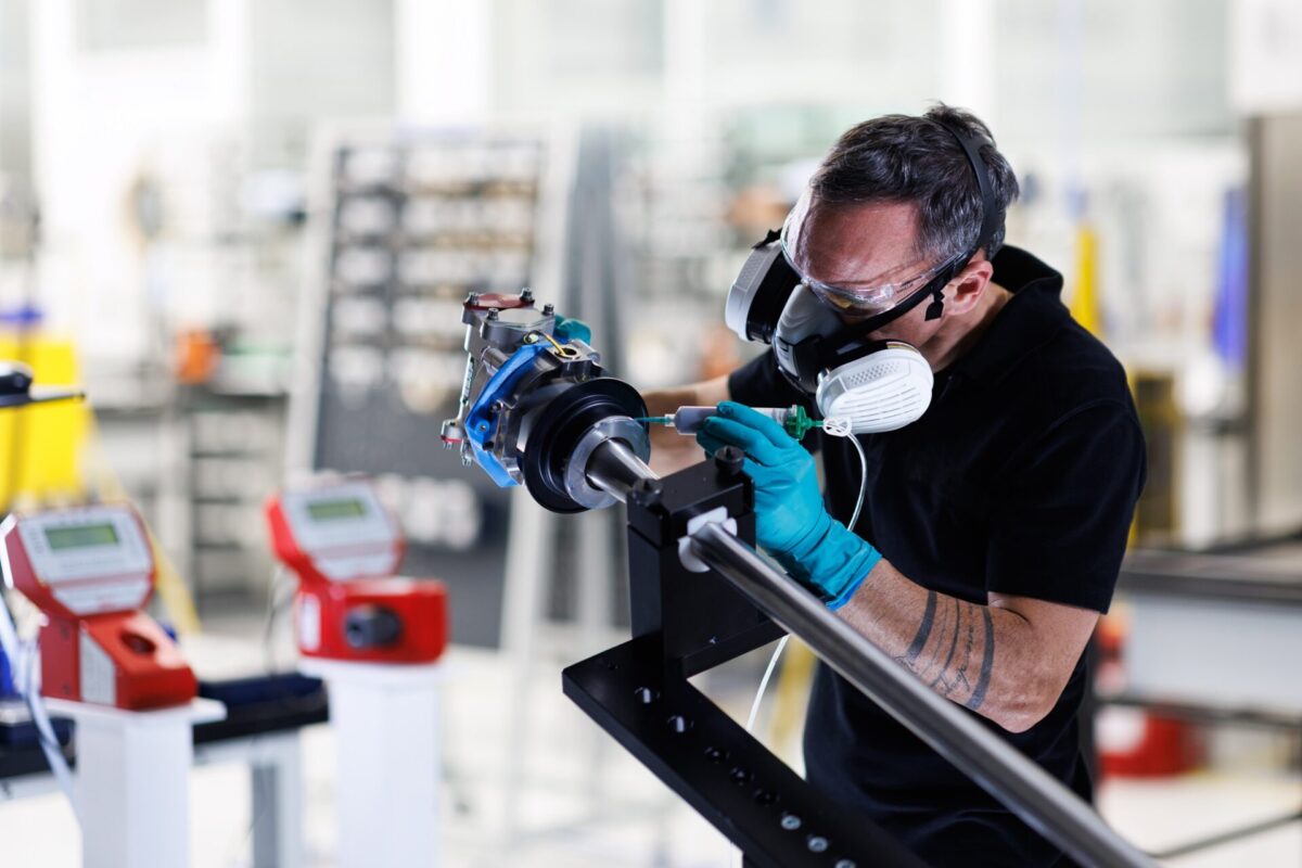 A Collins Aerospace technician applies sealant to an actuator part of the A350 electric thrust reverser actuation system elecTRAS on the new production line in Colomiers France