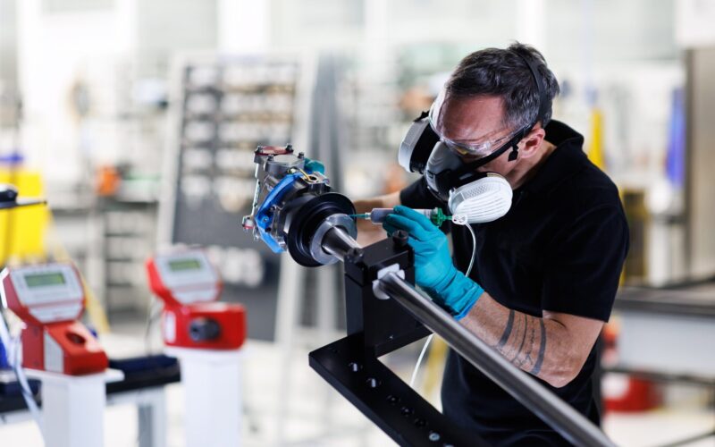 A Collins Aerospace technician applies sealant to an actuator part of the A350 electric thrust reverser actuation system elecTRAS on the new production line in Colomiers France