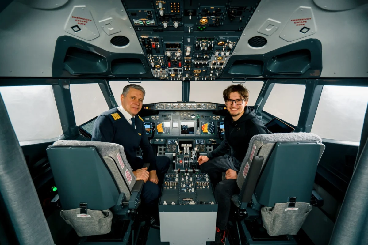 airplane cockpit pilot and young student boy smiling after training on flight simulator entertainment concept airplane cockpit pilot and young student boy smiling after training on flight simulator entertainment concept