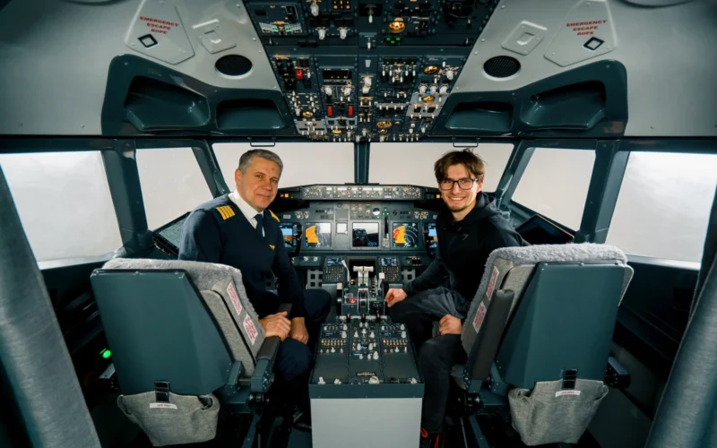 airplane cockpit pilot and young student boy smiling after training on flight simulator entertainment concept
