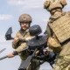 Ukrainian soldiers carrying a Baba Yaga heavy drone