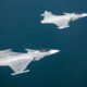 Two Saab Gripen E fighter jets flying in formation