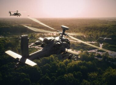 Two Apache attack helicopters flying alongside drones