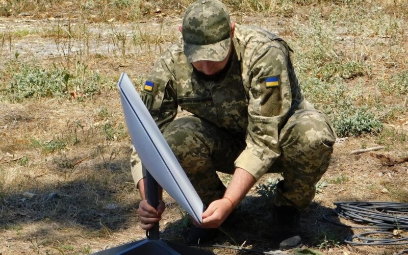 Ukraine soldier installing a Starlink terminal