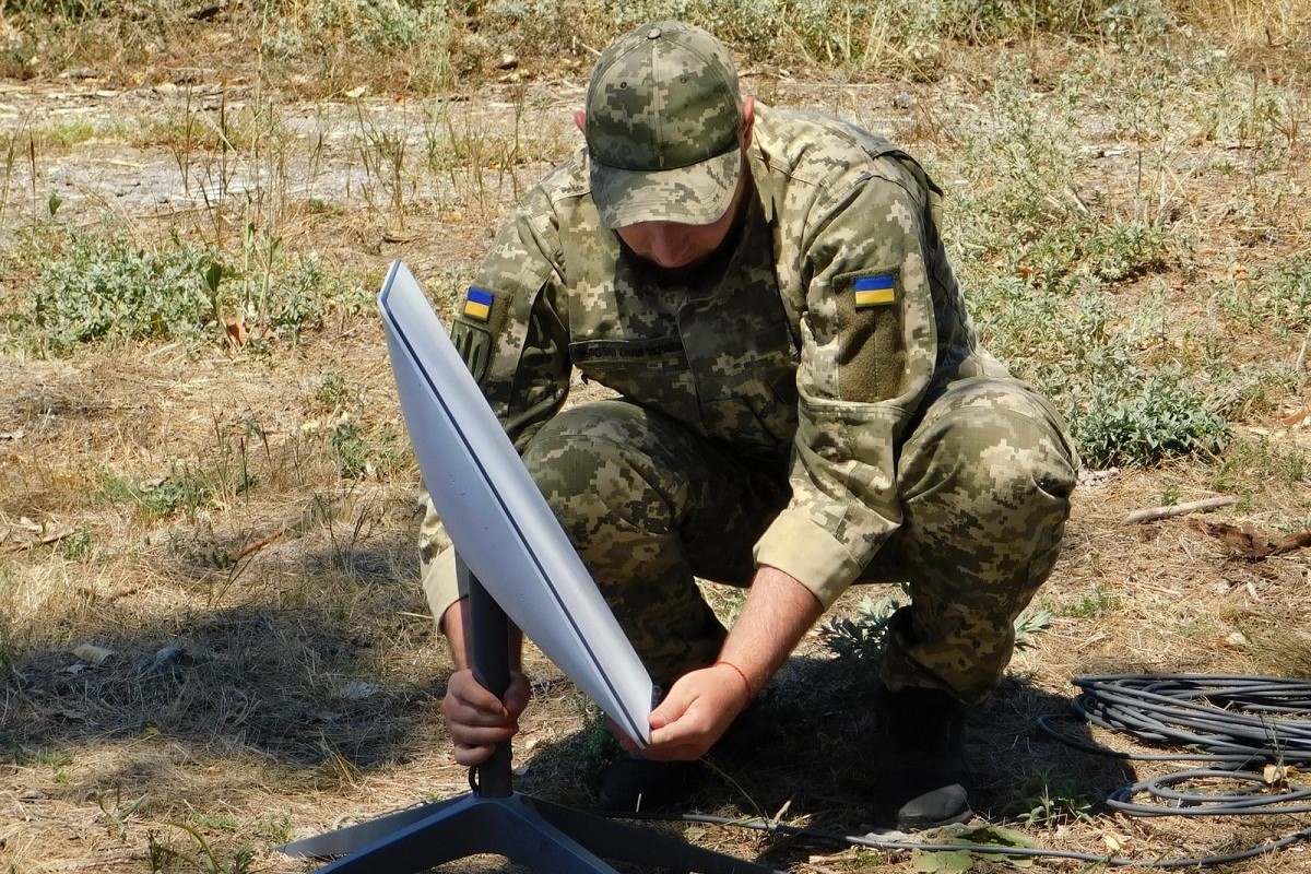 Ukraine soldier installing a Starlink terminal