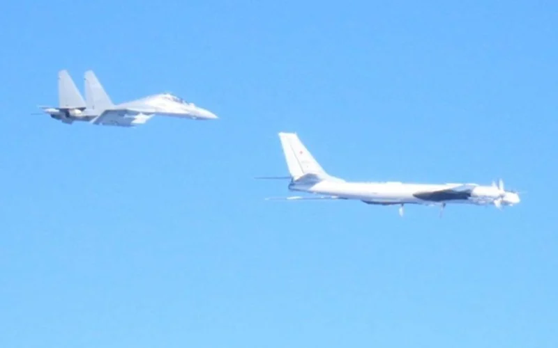 Russian Tu 95 strategic bomber escorted by Chinese J 16 fighter