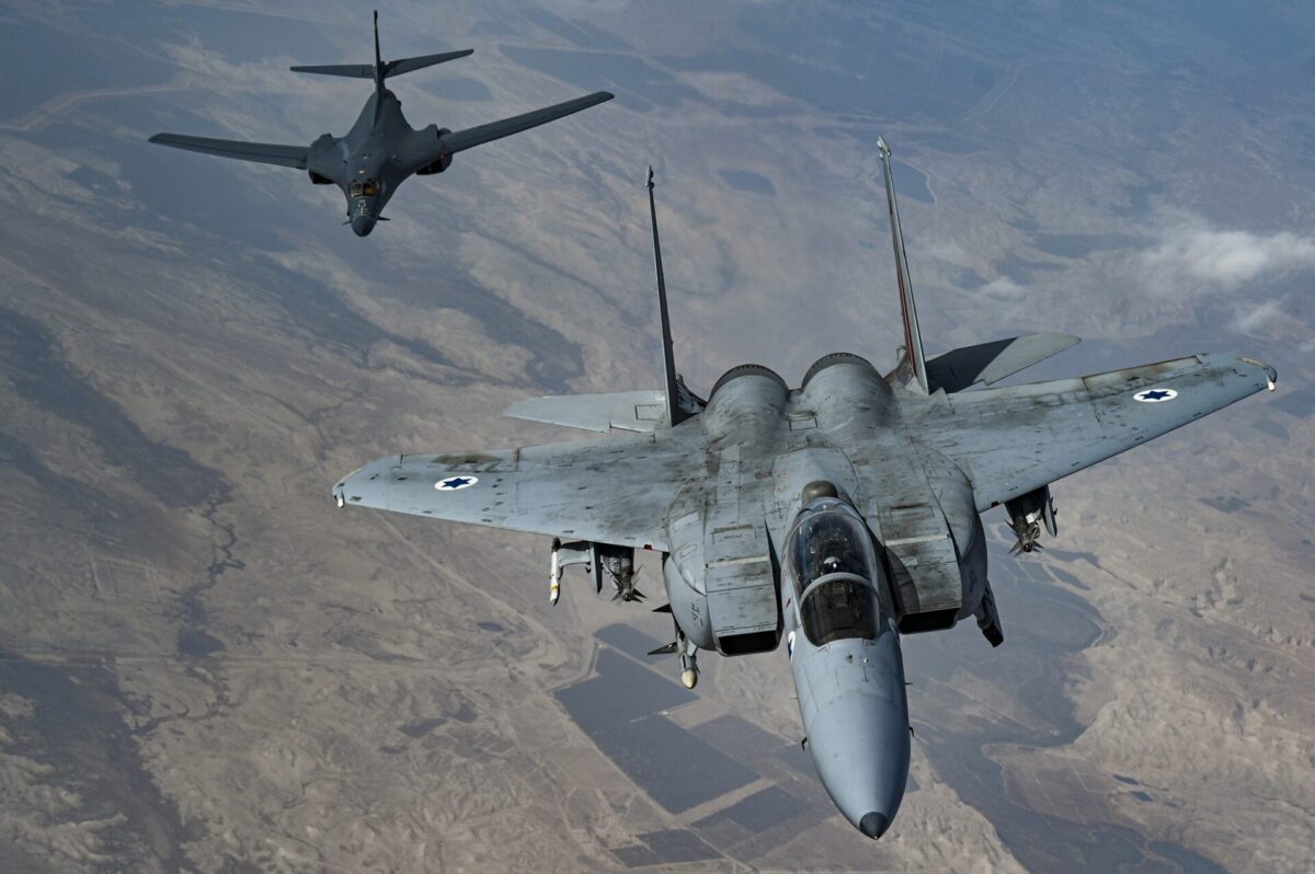 An Israeli Air Force F 15 Strike Eagle in formation with a US Air Force B 1B Lancer