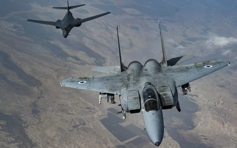 An Israeli Air Force F 15 Strike Eagle in formation with a US Air Force B 1B Lancer