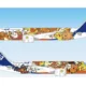 ANA passenger jet with colorful Pokémon characters painted along the fuselage blue sky backdrop