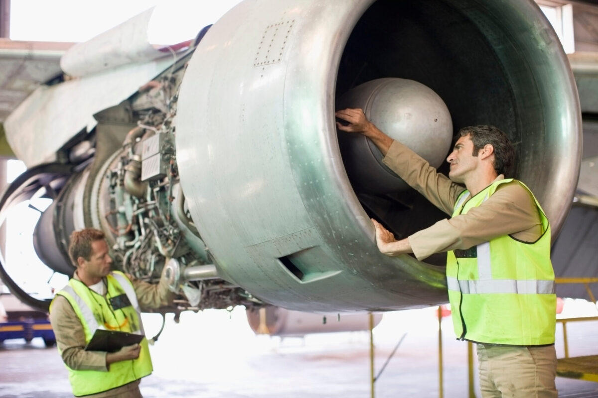 Aircraft workers checking airplane Aircraft workers checking airplane