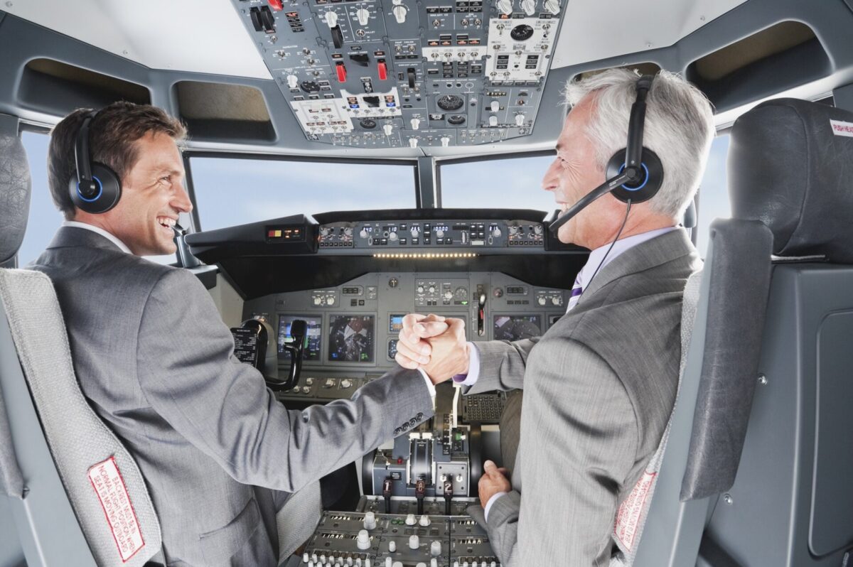 Germany Bavaria Munich Businessmen piloting aeroplane from airplane cockpit