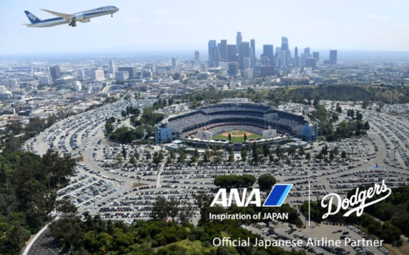 ANA Dodgers Aerial view of downtown Los Angeles with Dodger Stadium in the foreground and an ANA airplane taking off in the blue sky above