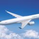 Cathay Cargo airplane in flight with a teal logo on the tail soaring above white clouds in a bright blue sky