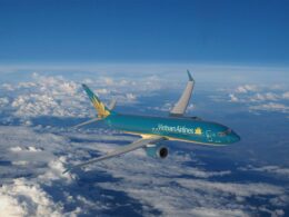 Vietnam Airlines passenger jet in turquoise livery cruising above white clouds