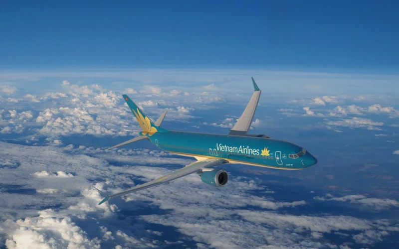 Vietnam Airlines passenger jet in turquoise livery cruising above white clouds