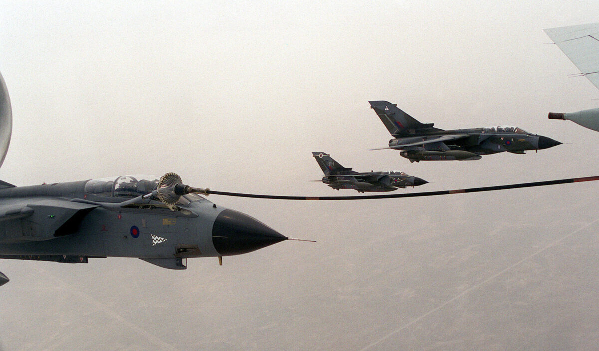 980320 N 3149V 007 Three RAF fighter jets fly in a close formation across a pale sky gray camouflage and sharp nose cones visible