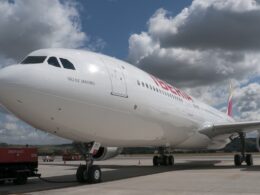 Iberia airliner on the tarmac forward fuselage visible with RIO DE JANEIRO lettering near the cockpit engines and landing gear shown