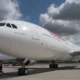 Iberia airliner on the tarmac forward fuselage visible with RIO DE JANEIRO lettering near the cockpit engines and landing gear shown