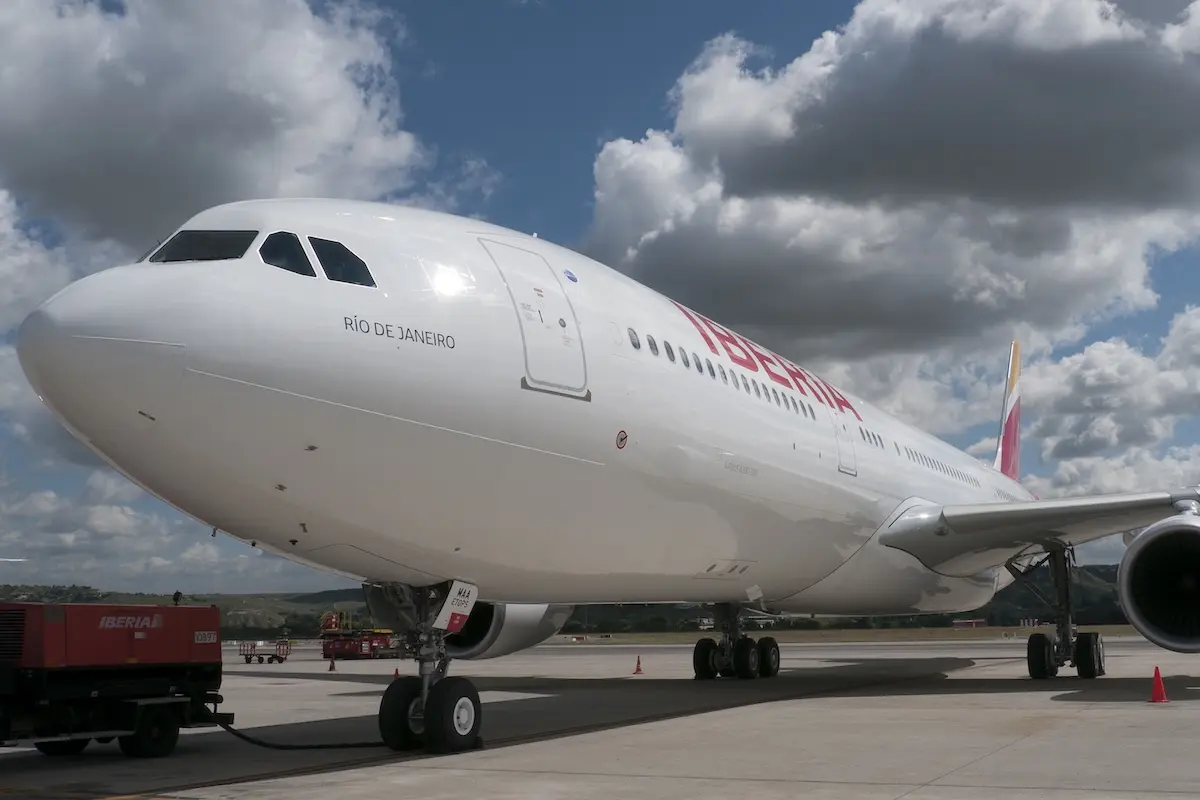 Iberia airliner on the tarmac forward fuselage visible with RIO DE JANEIRO lettering near the cockpit engines and landing gear shown