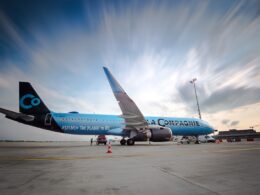Blue La Compagnie Airbus A321neo parked on the tarmac with ground crew and orange cones nearby at an airport
