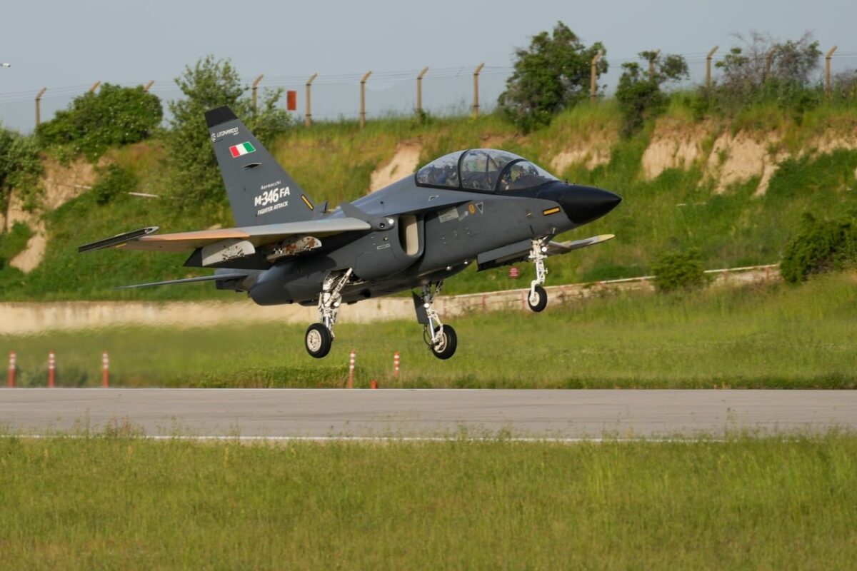 Leonardos M 346 Fighter Attack variant served as the crewed command aircraft during the K SWARM trials with Baykars Kizilelma drone Two seat M 346FA jet trainer lifting off from a runway with green fields and a fence in the background