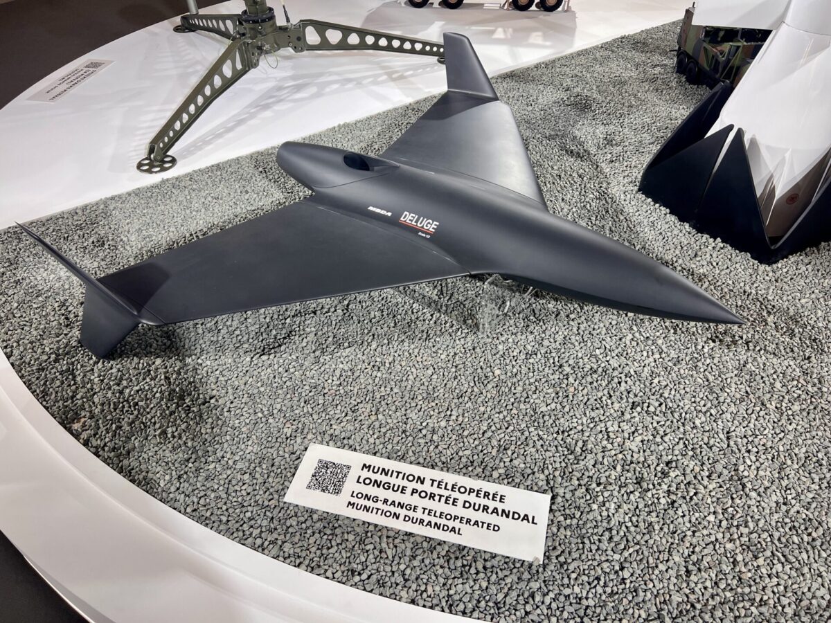 MBDAs DELUGE long range teleoperated munition also presented as Durandal displayed at Eurosatory 2026 Dark delta wing unmanned munition labeled Deluge on a gravel display at an exhibit A white display panel with French text is nearby still legible in the foreground
