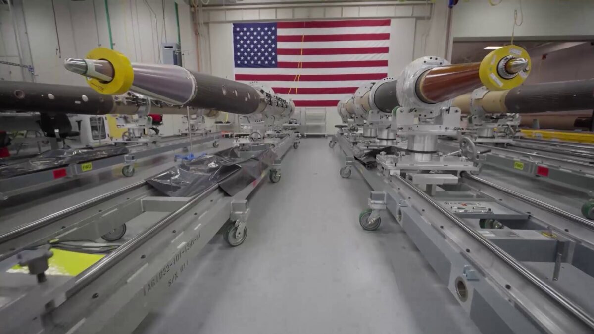 THAAD BRoll 1 Inside a rocket engine test facility large engines mounted on rails with yellow protective caps and an American flag on the back wall