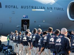 Line of Australian Defence Force personnel queueing to board a Royal Australian Air Force transport aircraft