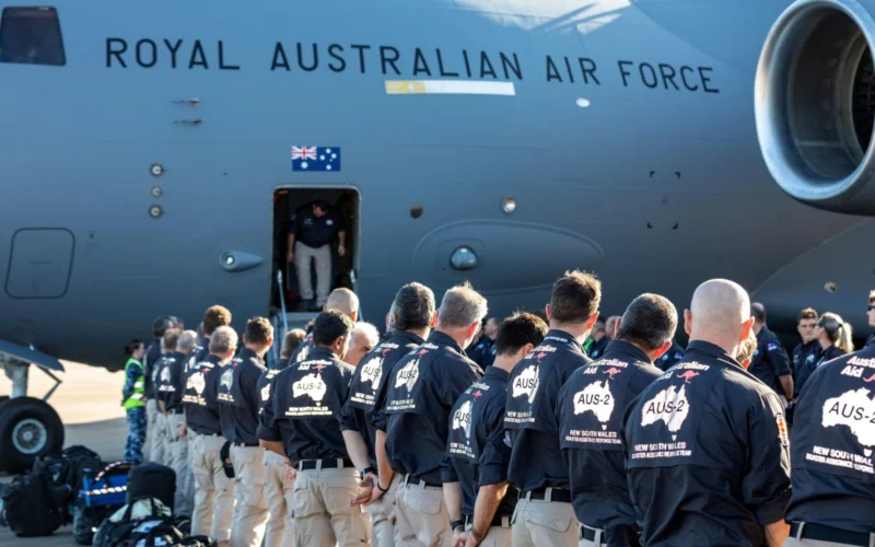 Line of Australian Defence Force personnel queueing to board a Royal Australian Air Force transport aircraft
