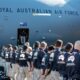 Line of Australian Defence Force personnel queueing to board a Royal Australian Air Force transport aircraft