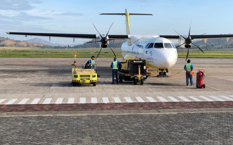Cebu Pacific to move AirSWIFT flights under Cebgo from July White twin engine ATR style aircraft parked on the tarmac while ground crew in high visibility vests operate yellow support equipment nearby