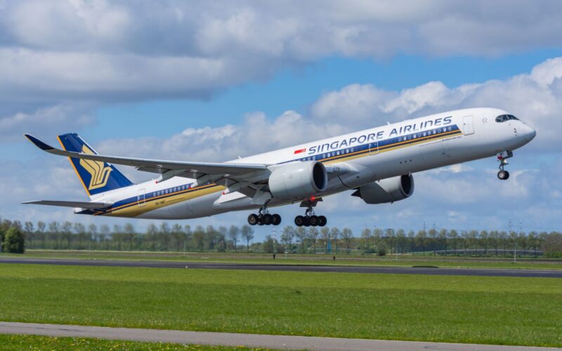 Singapore Airlines adds lawyer Adrian Chan to board Singapore Airlines passenger jet lifting off the runway wheels still extended under a partly cloudy blue sky