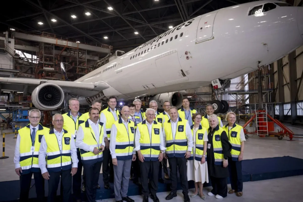 Lufthansa Technik expands at Clark Airport Philippines Group of airline staff in yellow safety vests posing in a hangar with a large white plane behind them