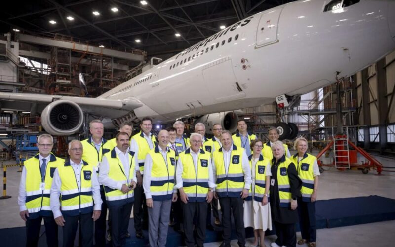 Lufthansa Technik expands at Clark Airport Philippines Group of airline staff in yellow safety vests posing in a hangar with a large white plane behind them