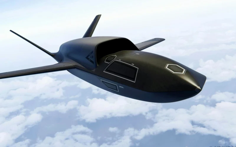 Dark sleek unmanned aircraft with swept back wings flying above clouds in a clear sky