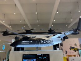 Suspended Honda Experimental N241RX tilt rotor aircraft on display at an exhibition booth
