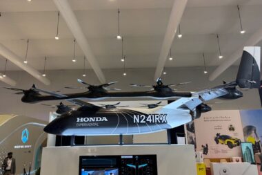 Suspended Honda Experimental N241RX tilt rotor aircraft on display at an exhibition booth