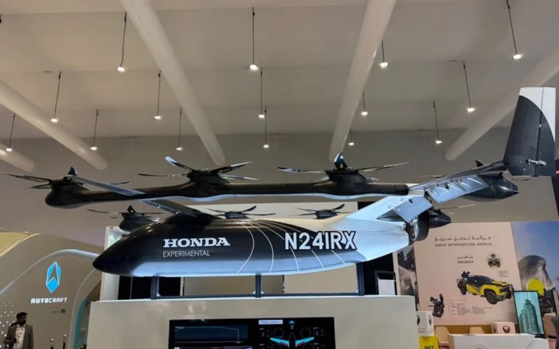 Suspended Honda Experimental N241RX tilt rotor aircraft on display at an exhibition booth