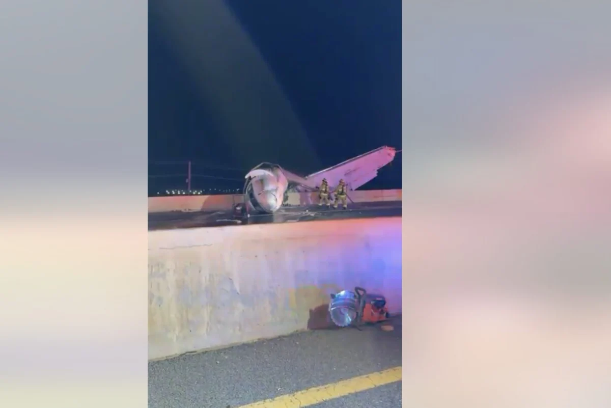 laredo crash snap Night scene of a crashed small airplane on a highway barrier with firefighters examining the wreckage and debris on the roadlighted by emergency vehicles