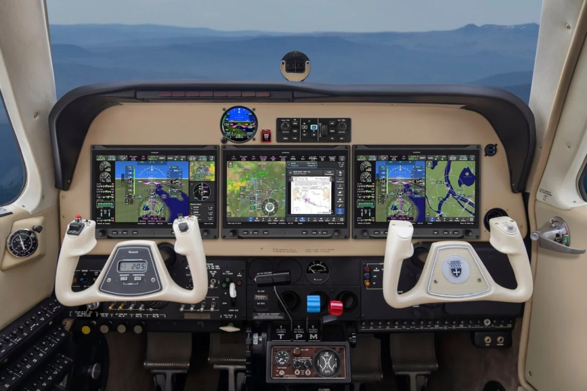20251118 Support AVN 0381V2 HERO copy 2 1480x986 Modern airplane cockpit with four widescreen flight displays dual control yokes and cockpit controls visible below the screens