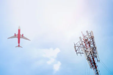 5G post and plane on sky background