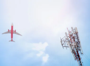 5G post and plane on sky background